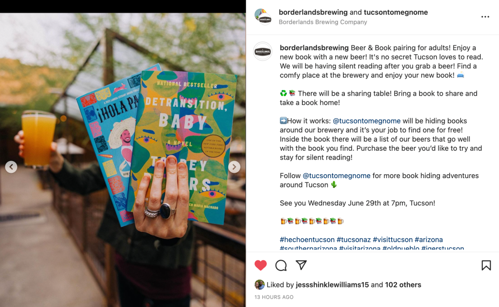 Image of a person holding two books and a pint of beer.